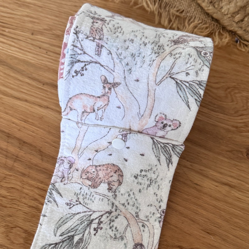 Fabric strip with nature-themed design on a wooden surface