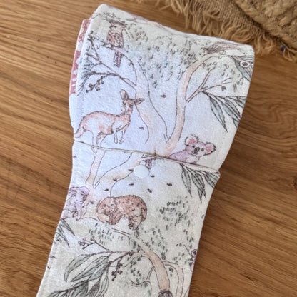 Fabric strip with nature-themed design on a wooden surface