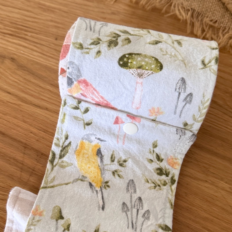 Fabric strip with nature-themed design on a wooden surface