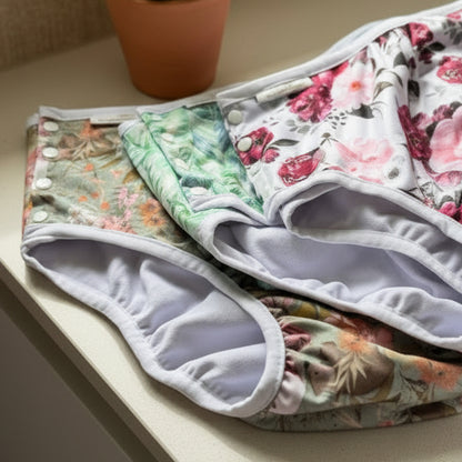 Stack of floral-patterned underwear on a beige surface