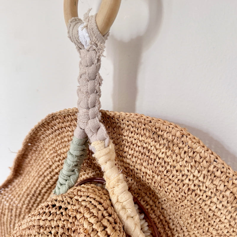 Woven bag with a handle made of braided natural fibers against a light background