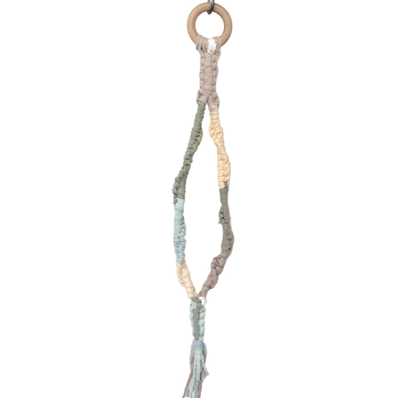 Macrame plant hanger with natural wood elements on a white background