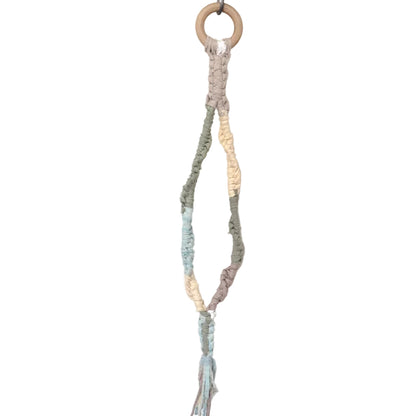 Macrame plant hanger with natural wood elements on a white background